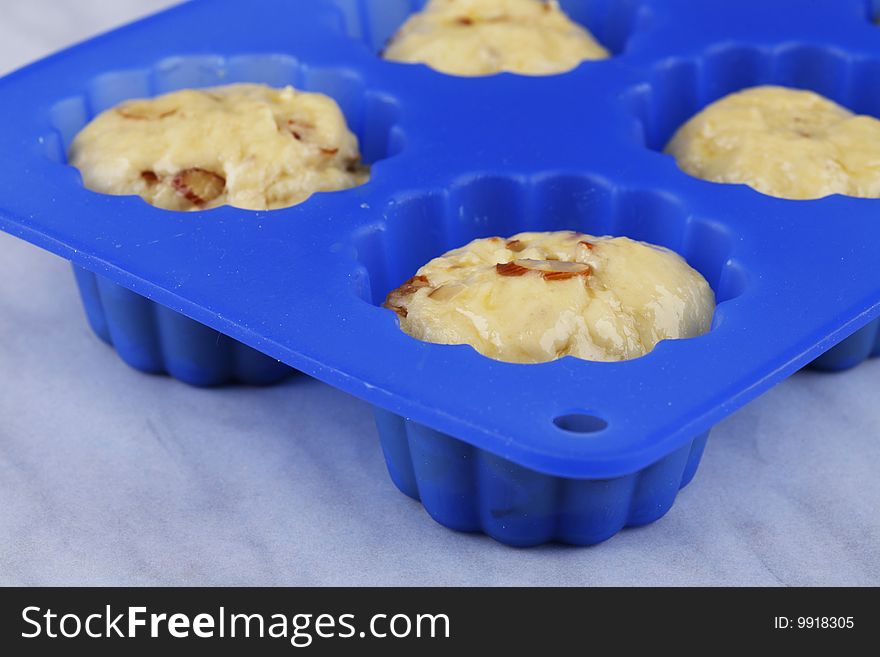 The crude dough in silicone form on a white background (Easter cakes). The crude dough in silicone form on a white background (Easter cakes)