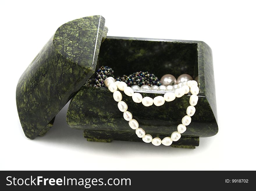Treasure chest filled with pearl collier isolated on white background