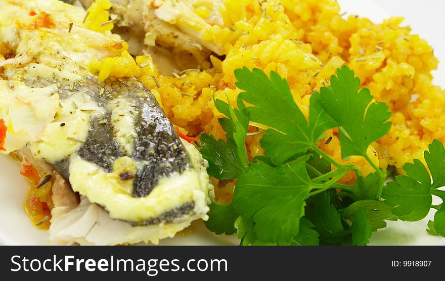 Baked fish with rice and green parsley