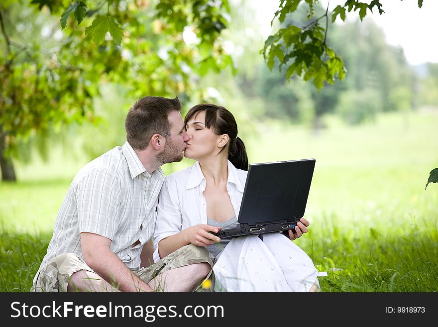 Happy young couple relaxing in park. Happy young couple relaxing in park