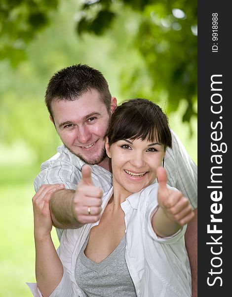 Happy young couple relaxing in park. Happy young couple relaxing in park