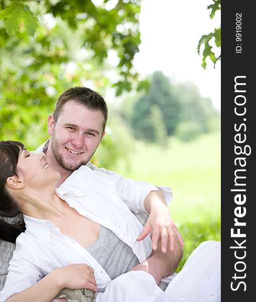 Happy young couple relaxing in park. Happy young couple relaxing in park