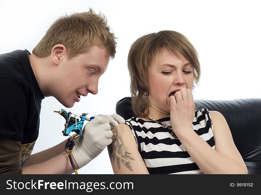 An image of a man drawing adornment  on woman arm