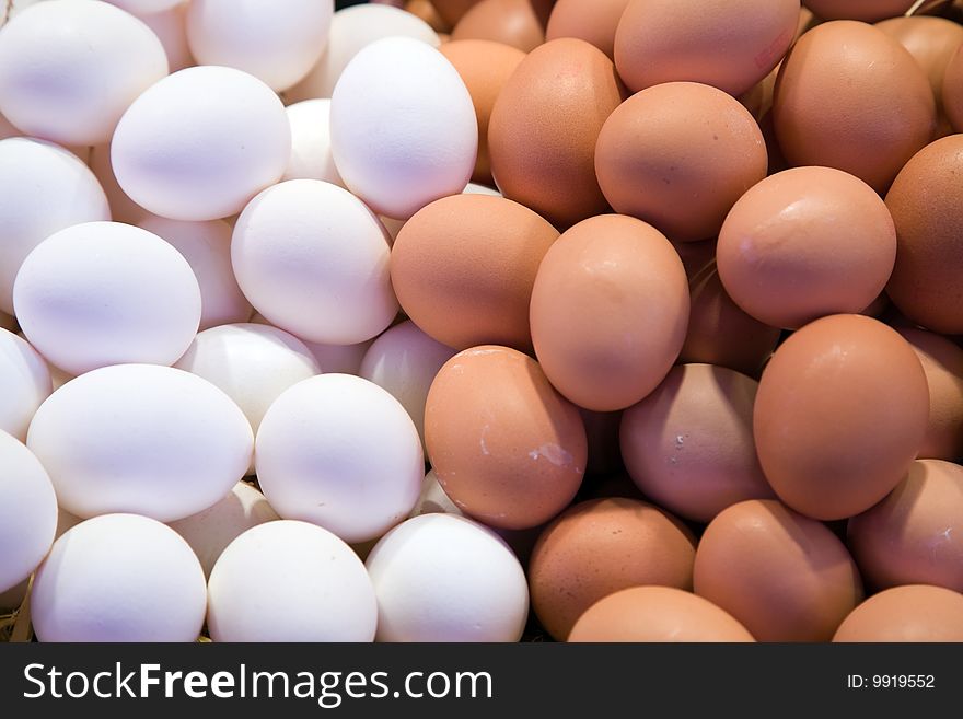 Fresh white and brown eggs on the market.