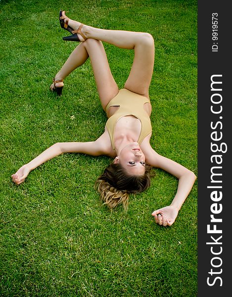 Female fashion model relaxing on the grass. Female fashion model relaxing on the grass
