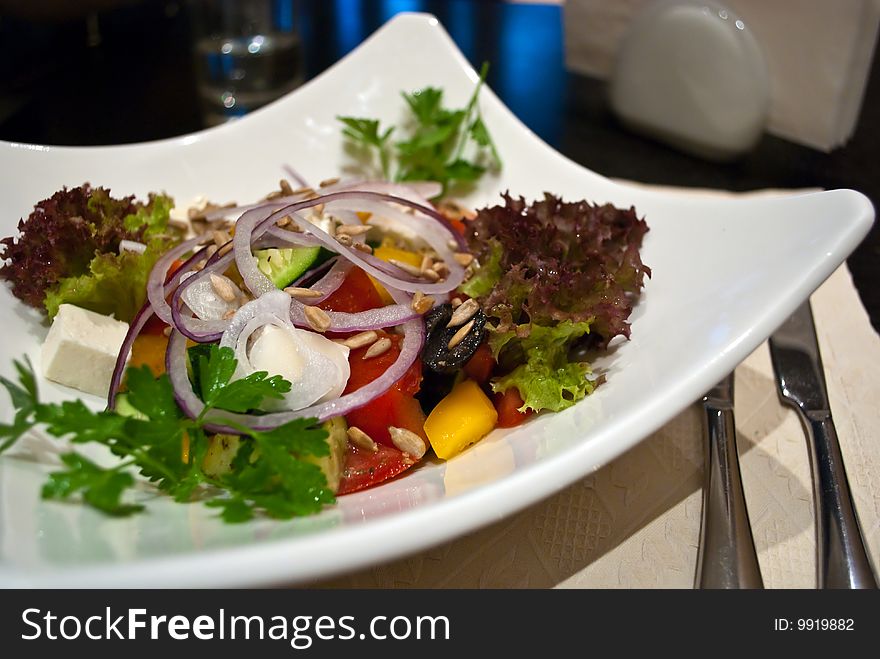 Healthy Greek salad with olives, tomatoes, cucumber, red onion, and cheese feta.