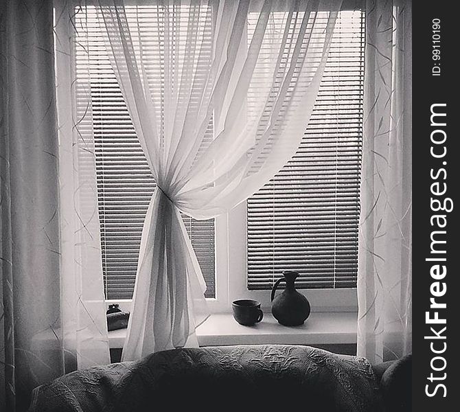 Black and white of curtains and blinds that are open in a home. Black and white of curtains and blinds that are open in a home.