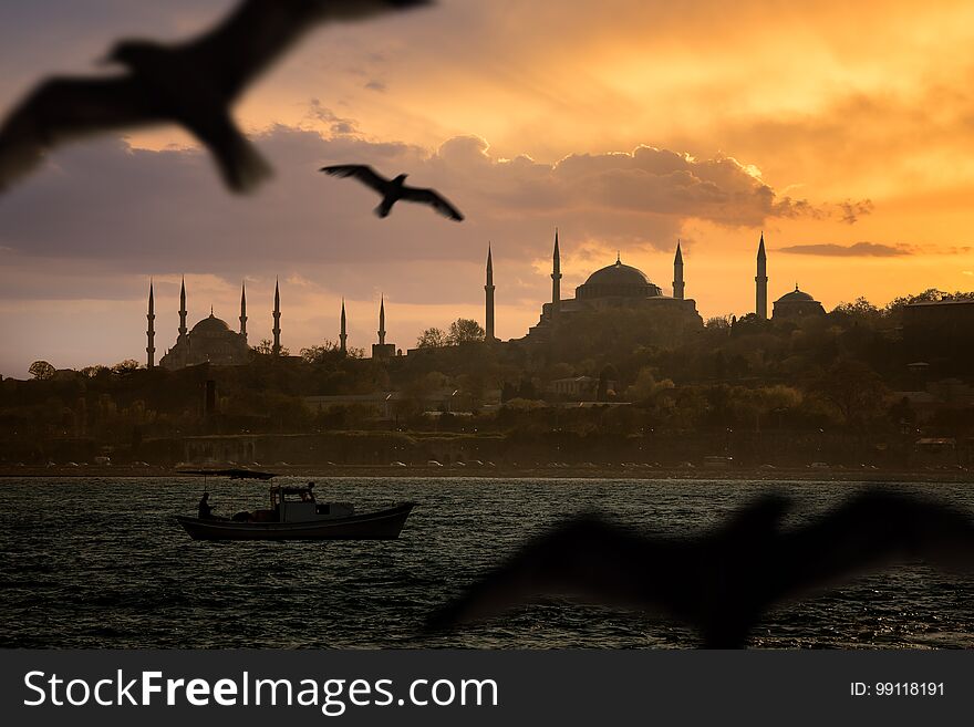 Iconic Istanbul Old Town silhouette and the fishing boat during sunset. Iconic Istanbul Old Town silhouette and the fishing boat during sunset