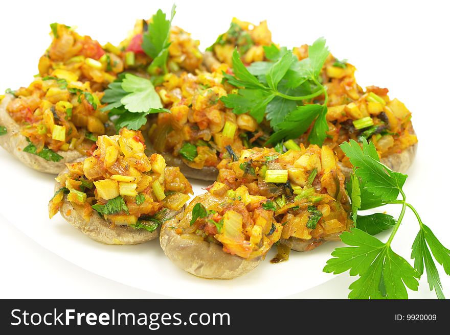 Delicious mushrooms stuffed with vegetables on white