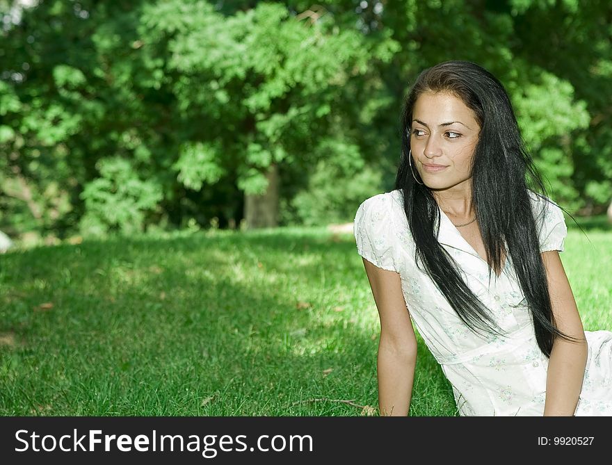 Attractive girl sitting on the grass