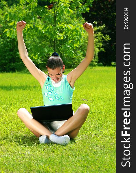 Young woman on a nature with the laptop