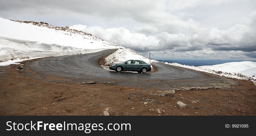 Car Going Around A Hairpin Turn On Mountain Road