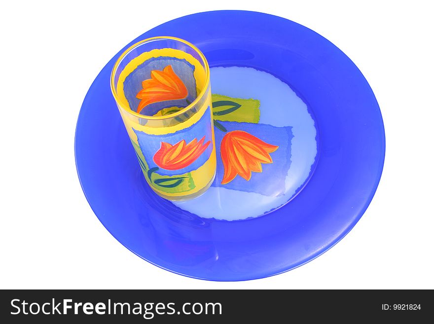 Plate and glass of dark blue and yellow colour on a white background