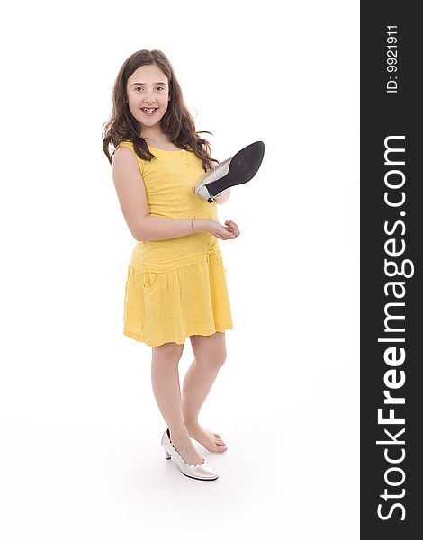 A beautiful and young girl playing with mom's shoes. A beautiful and young girl playing with mom's shoes