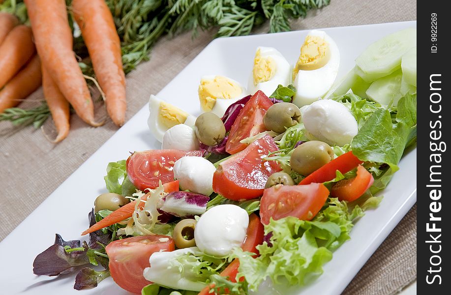 Healthy salad with eggs cherries and olives