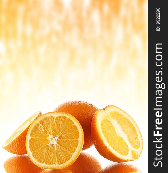 Group of oranges on mirror surface with abstract background