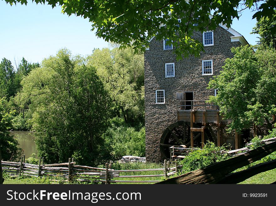 The old building of watermill on the beach of pond. The old building of watermill on the beach of pond