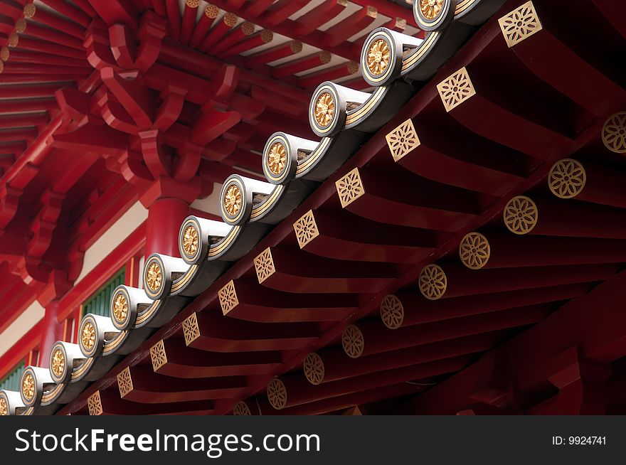 An illuminated roof's edge in a Buddhist temple build in classical Chinese architectural style, in Chinatown, Singapore. An illuminated roof's edge in a Buddhist temple build in classical Chinese architectural style, in Chinatown, Singapore