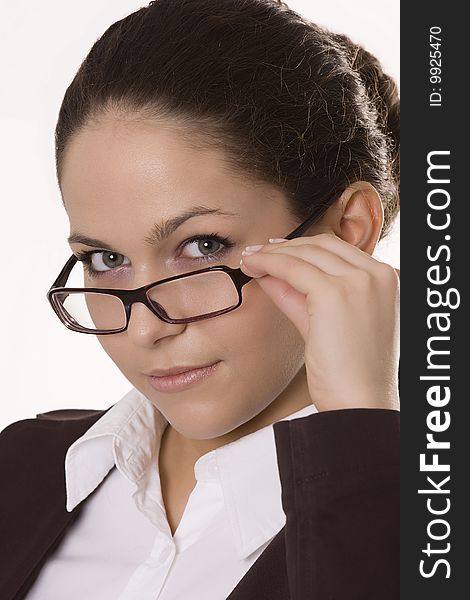 Young woman looking over the top of her glasses. Young woman looking over the top of her glasses