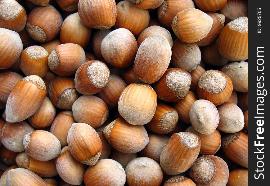 Unshelled organic hazelnuts background. Delicious healthy food.