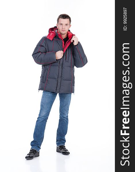 Young man in winter warm down jacket on isolated background. Young man in winter warm down jacket on isolated background