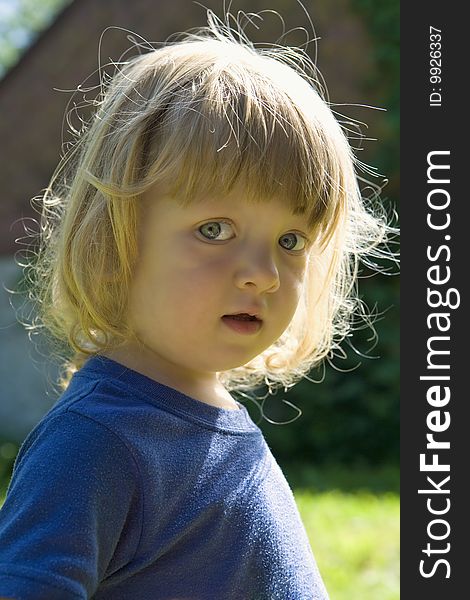 Outdoor portrait of a beautiful boy with long blond hair. Outdoor portrait of a beautiful boy with long blond hair