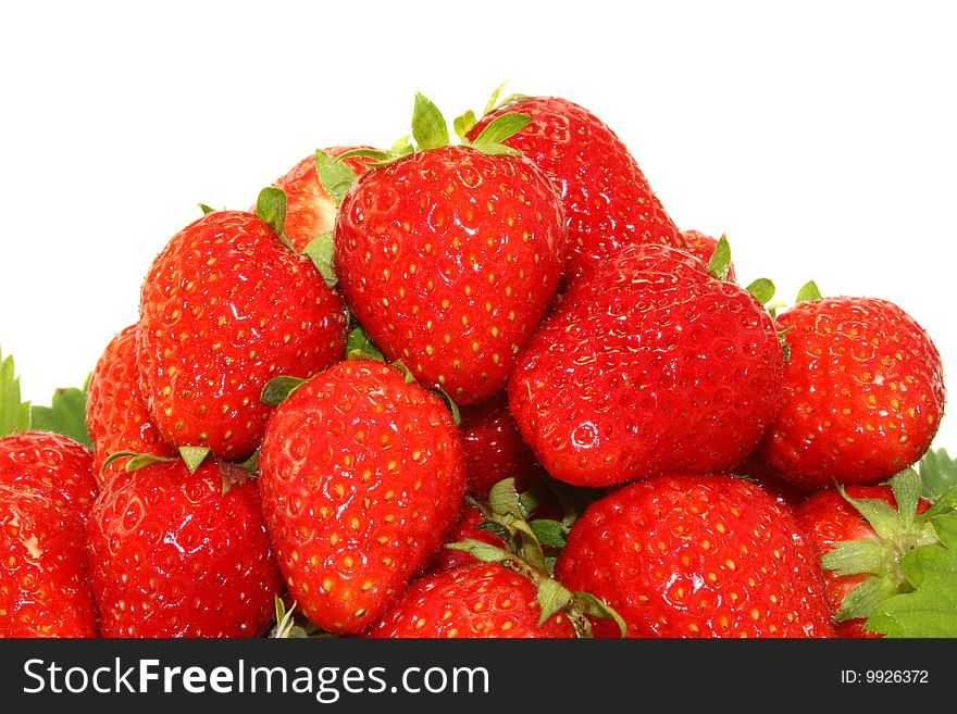 A lot of the red strawberry on a white background, is isolated.