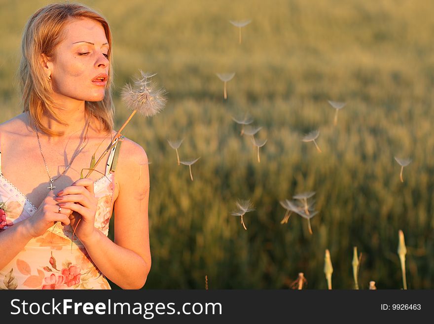 There are woman and dandelion