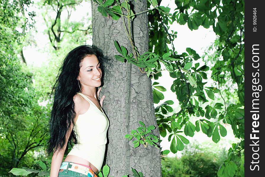 Pretty girl next to a tree in the forest. Pretty girl next to a tree in the forest