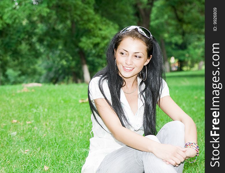 Girl sitting in the park on a sunny day. Girl sitting in the park on a sunny day