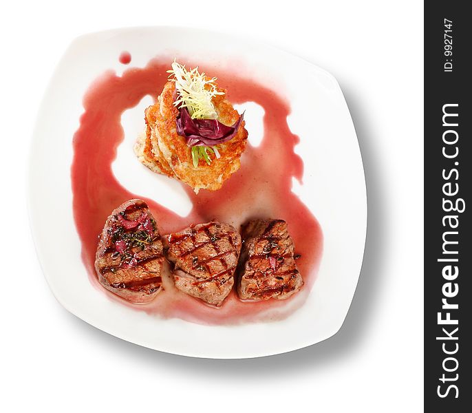 Veal Medallions with potato pancakes. Closeup. File includes clipping path for easy background removing