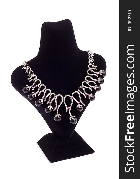 Necklace with black pearls on black stand