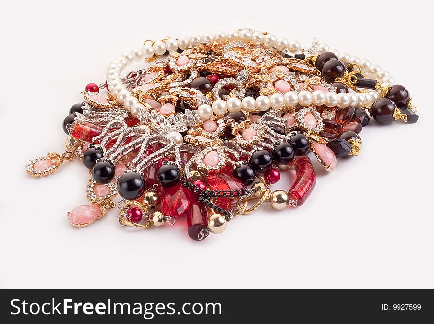 A pile of colored jewellery on white background