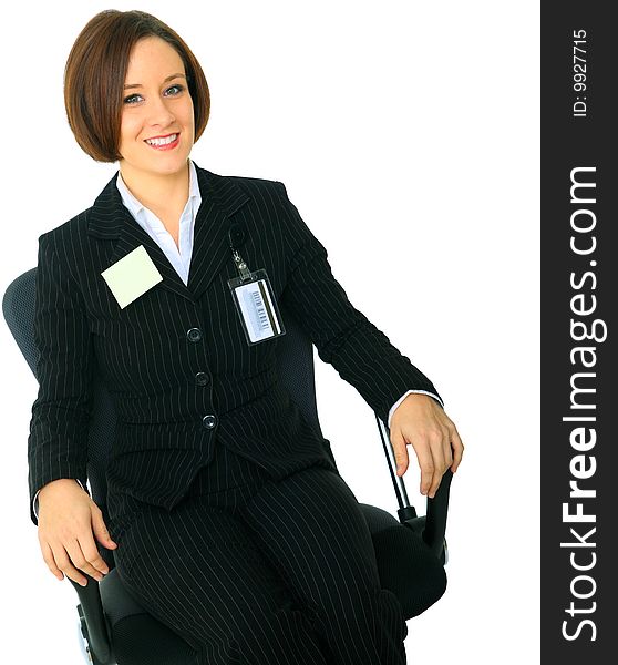 Smiling caucasian female boss sit on chair has one empty blank post it note on her suit. Smiling caucasian female boss sit on chair has one empty blank post it note on her suit