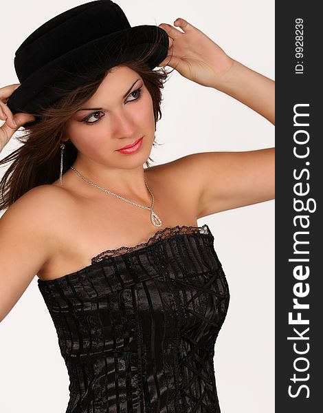 Young woman wearing black corset and an hat. Young woman wearing black corset and an hat
