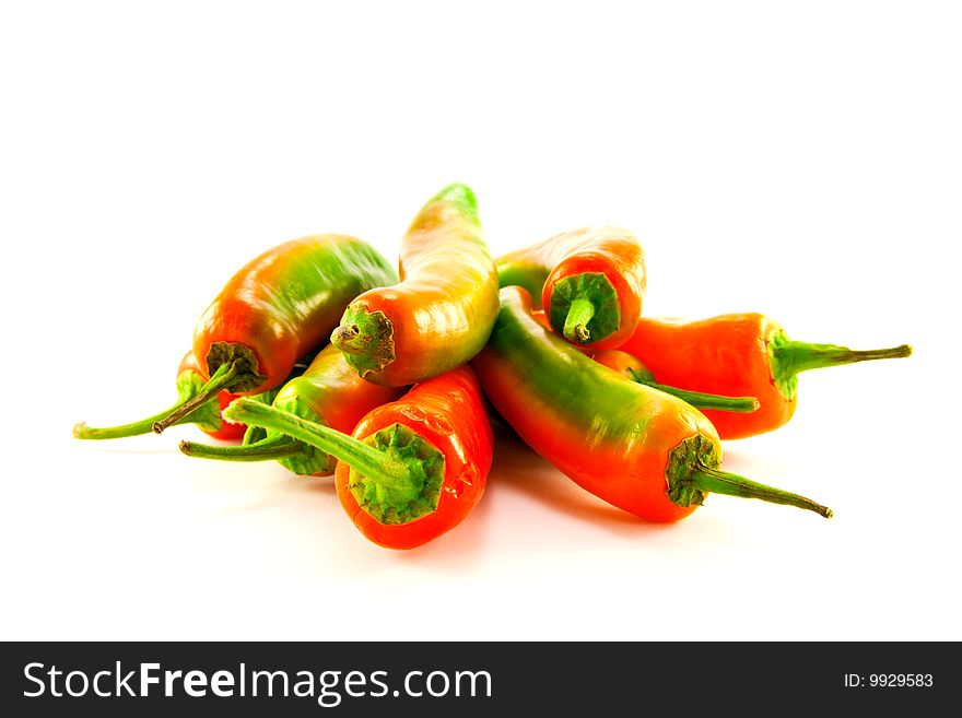 Pile of red and green chillis with clipping path on a white background. Pile of red and green chillis with clipping path on a white background