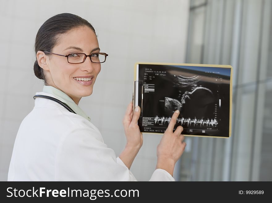 Close up of female doctor holding xray film. Close up of female doctor holding xray film