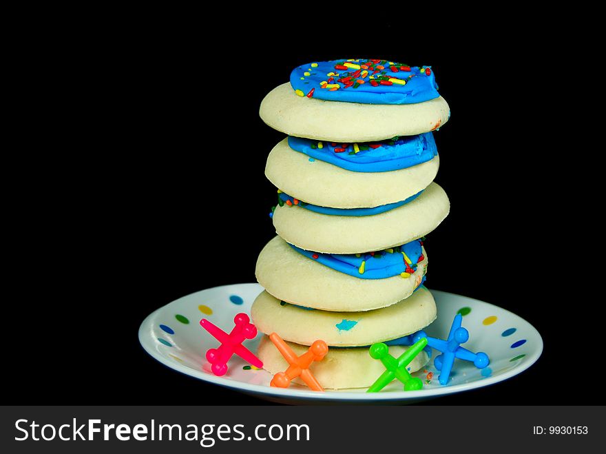Stack of sugar cookies with toy jacks. Stack of sugar cookies with toy jacks.
