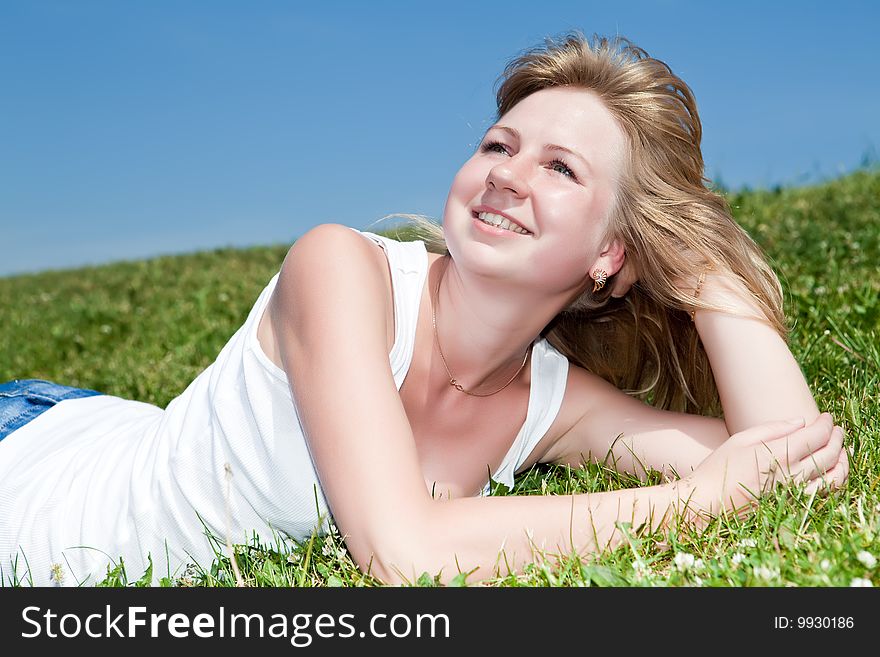 Girl have a rest on a green grass