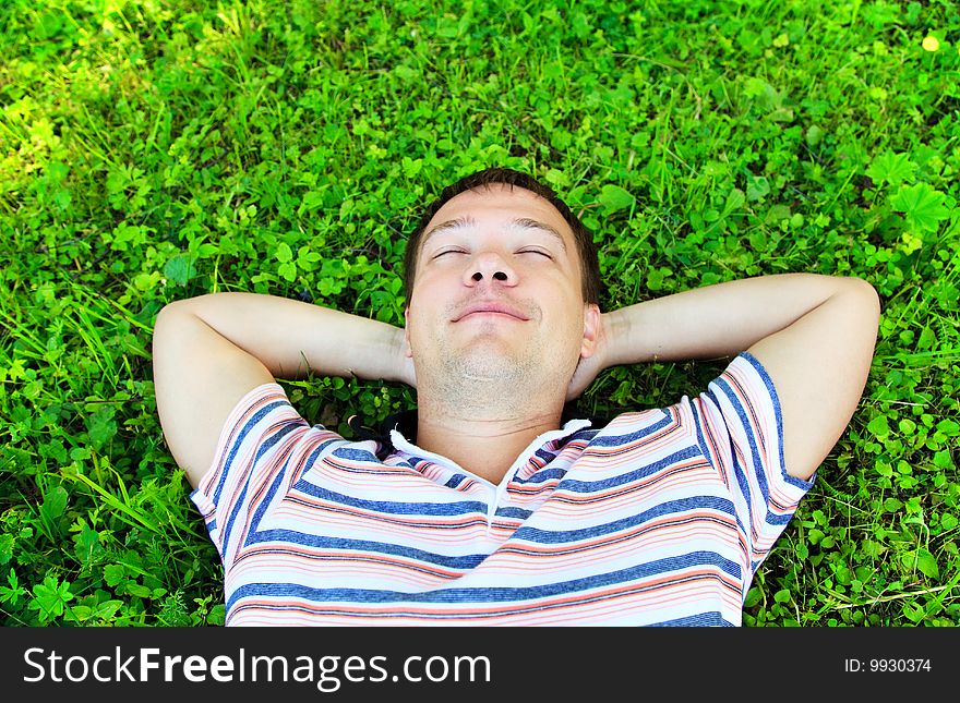 Young Man Lying On The Grass