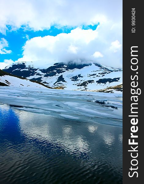 Landscape With Winter Lake Under Sky With Clouds