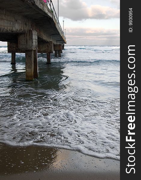 Concrete old bridge over sea and dramatic sky