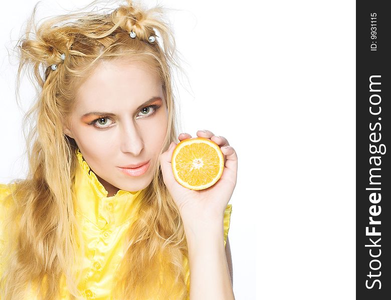 Young girl in yellow dress with piece of orange. Young girl in yellow dress with piece of orange