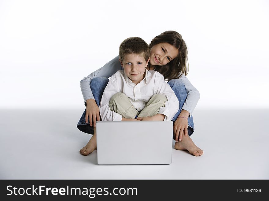 Friendly boy and girl with computer