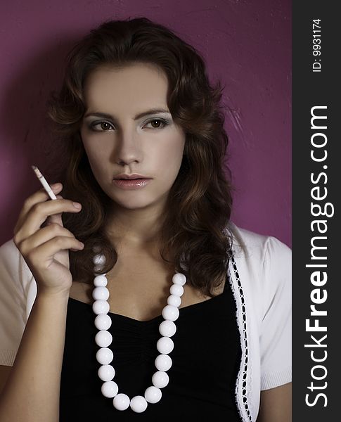 Portrait of young woman smoking cigarette. Portrait of young woman smoking cigarette