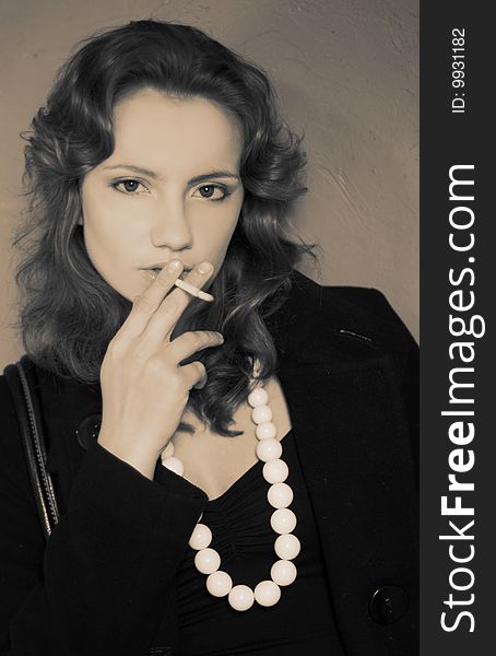 Portrait of young woman smoking cigarette. Portrait of young woman smoking cigarette