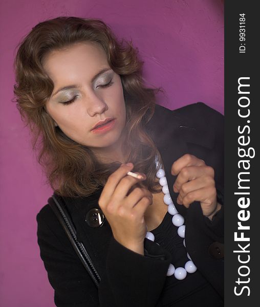 Portrait of young woman smoking cigarette. Portrait of young woman smoking cigarette