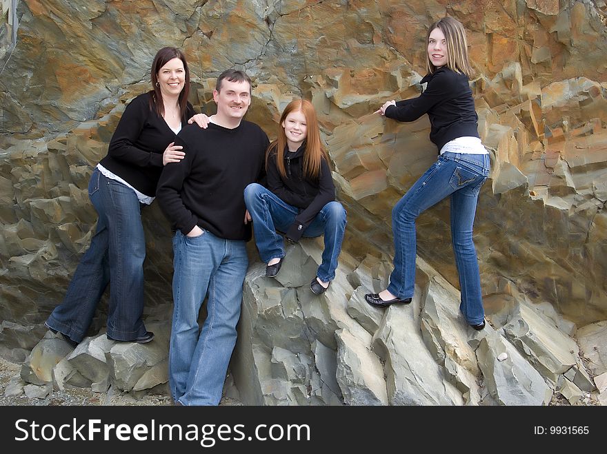 Portrait of parents, tween and teen girls with cliff background that was once an ocean floor. Portrait of parents, tween and teen girls with cliff background that was once an ocean floor