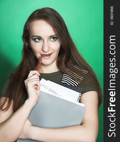 Portrait of student girl with copybooks in her hands.