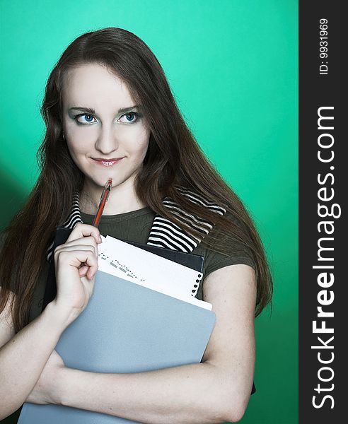 Portrait of student girl with copybooks in her hands.